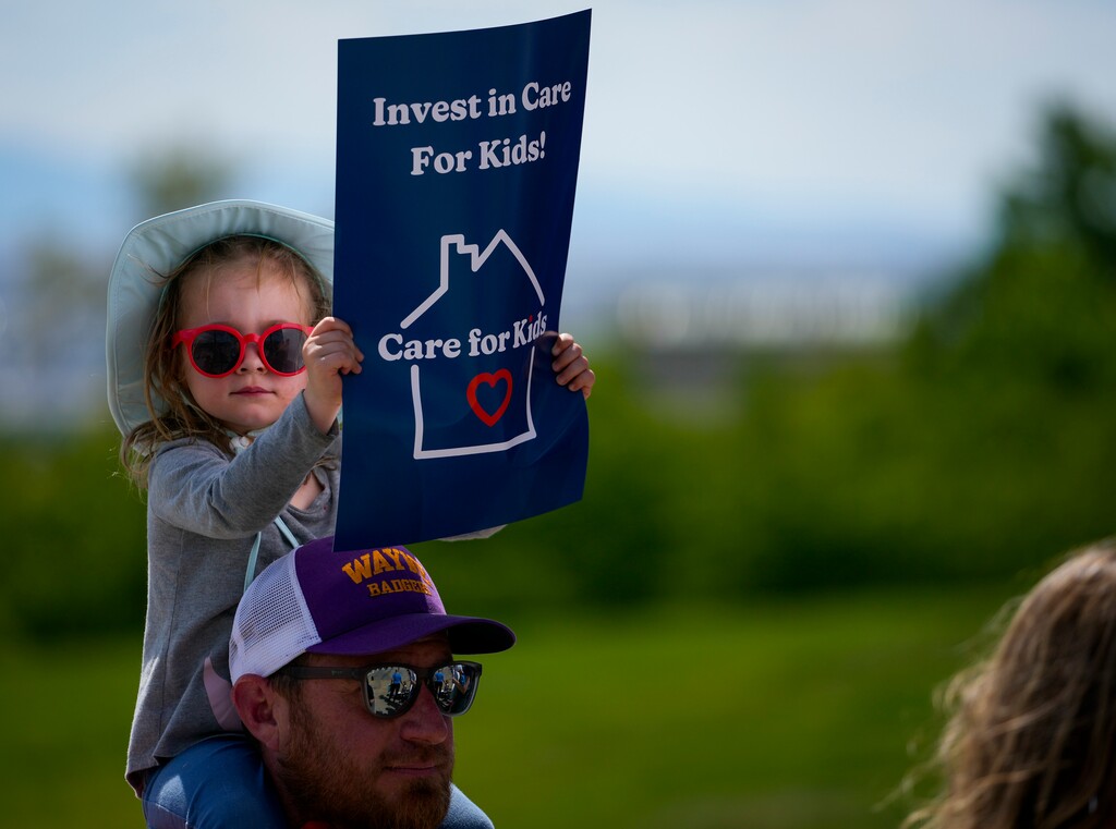 (Bethany Baker  |  The Salt Lake Tribune) A child holds up a sign during a rally to demand funding for childcare at the Capitol in May 2024.