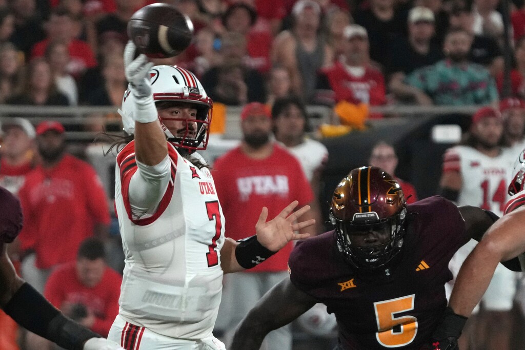 (Rick Scuteri | AP) Utah quarterback Cameron Rising throws down field away from Arizona State defensive lineman Jeff Clark in the first half during an NCAA college football game, Friday, Oct. 11, 2024, in Tempe, Ariz.
