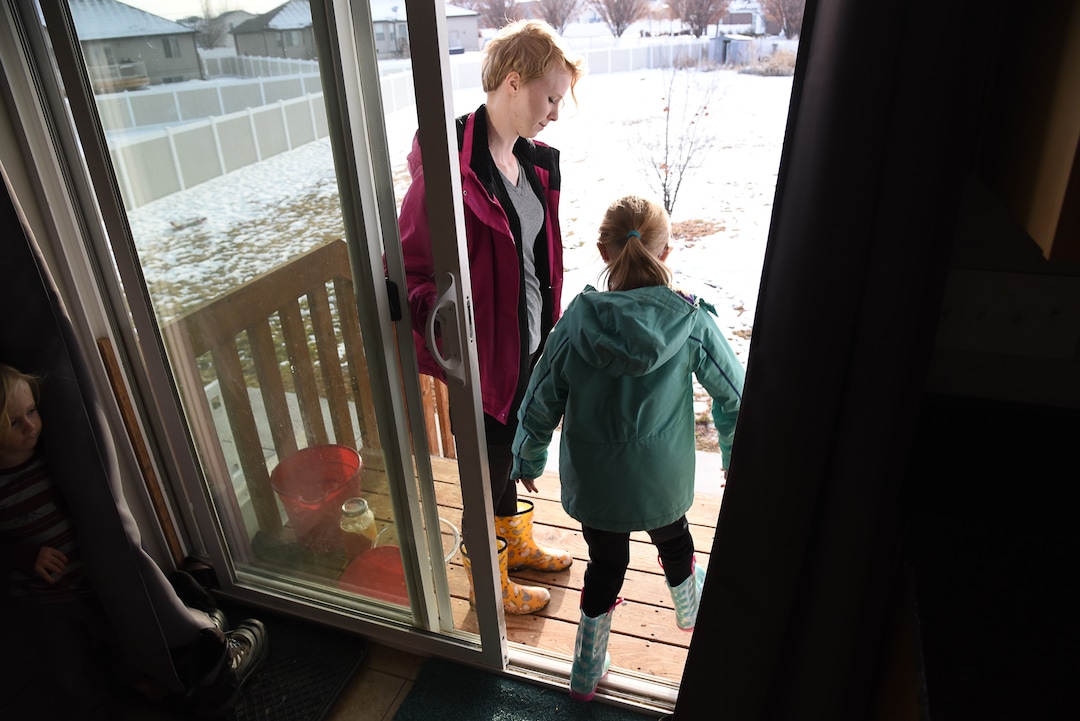 (Francisco Kjolseth  |  The Salt Lake Tribune)  With rubber boots on, Natalie Sacks and her daughter Skyrie, 7, head out to visit with their eight chickens at their home in West Clinton on Wed. Jan. 9, 2018. Natalie Sacks says emotional support chickens have helped her daughter deal with PTSD from a traumatic accident that happened when she was 4. The Sacks family had to move from their home in Herriman because of an HOA dispute over the chickens.