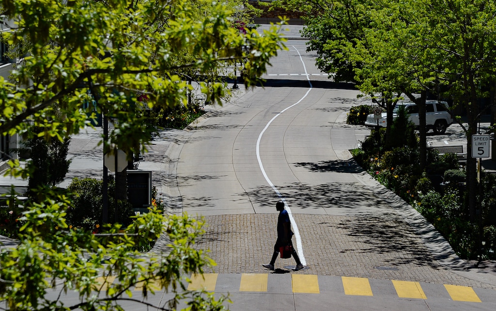 (Francisco Kjolseth  |  Tribune file photo) A pedestrian makes their way past an empty Gateway Mall in downtown Salt Lake City on Wednesday, April 29, 2020.