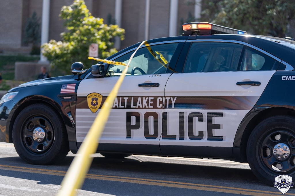 (SLCPD) A Salt Lake City Police Department patrol car at a crime scene in September. A Salt Lake City police officer was charged with sexual battery after he allegedly hit a woman on the butt with a boxing glove during a work training this summer.