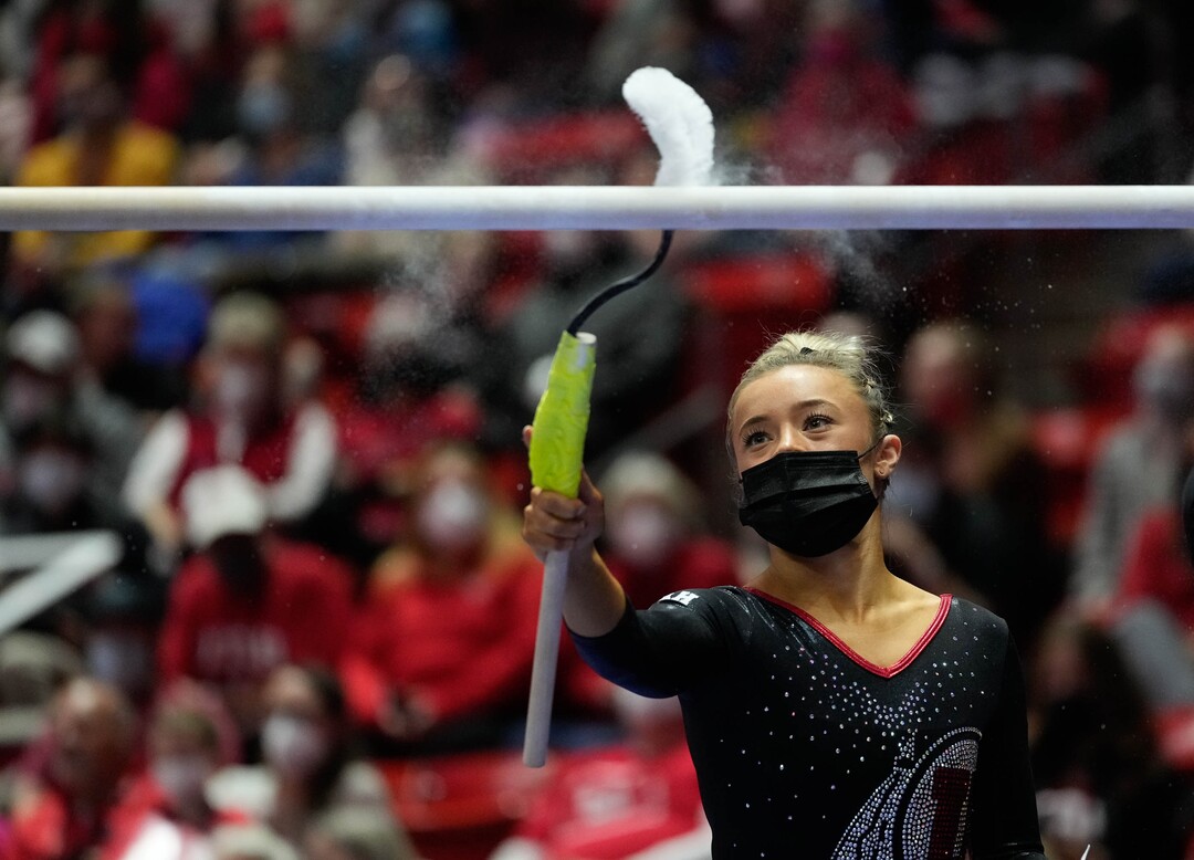 (Francisco Kjolseth | The Salt Lake Tribune) Utah’s Sydney Soloski cleans the bars of excess chalk during their gymnastics meet with Stanford at the Huntsman Center in Salt Lake City, Saturday, Jan. 29, 2022.