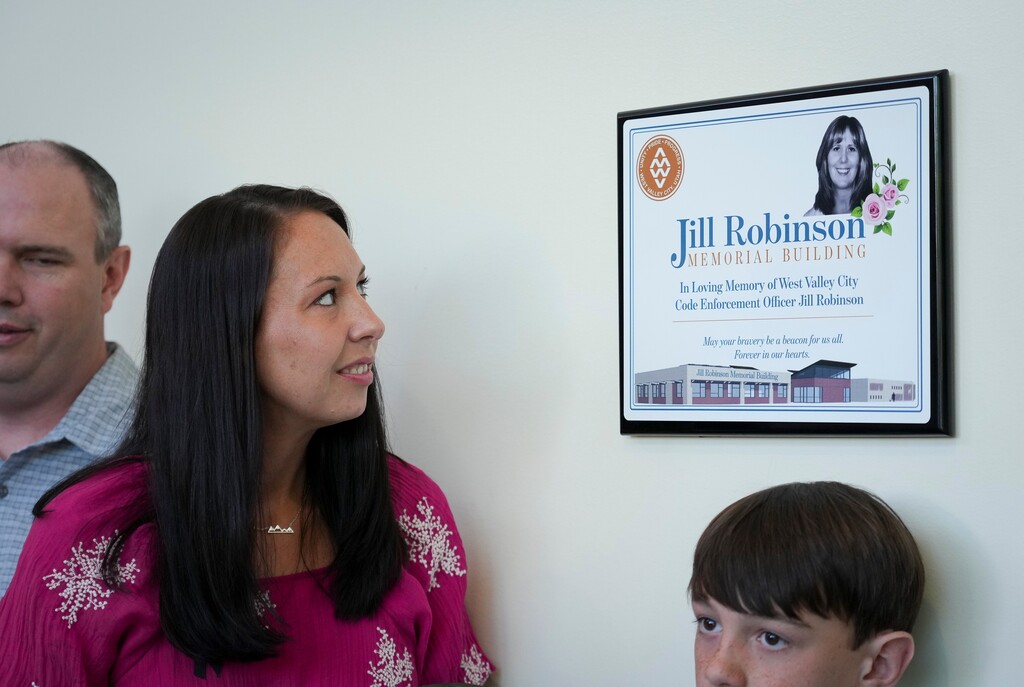 (Bethany Baker | The Salt Lake Tribune) Jessica Knorr, daughter of Jill Robinson, looks at one of the signs honoring her mother inside the Jill Robinson Memorial Building in West Valley City on Thursday, July 31, 2025.