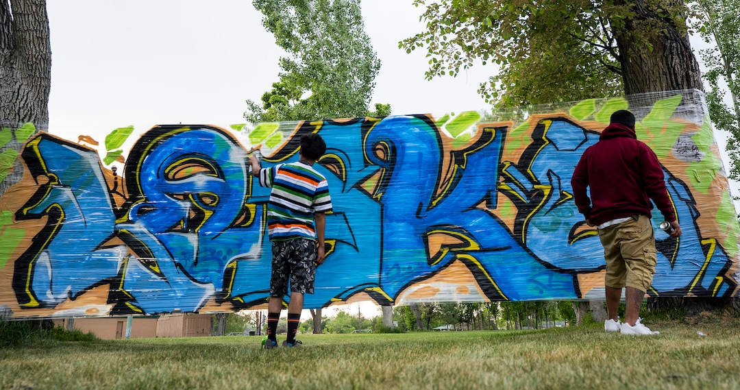 (Rick Egan | The Salt Lake Tribune) Friends of Bernardo, paint a mural on plastic stretched between two trees, during the "Long Live Loske" gathering at Rose Park on Saturday, May 22, 2021. The family of Bernardo Palacios-Carbajal hosted a "1st Heavenly Anniversary" event to celebrate the life of their son and brother to mark the 1-year anniversary of his death on May 23, 2020 by Salt Lake City Police, who fired 34 shots, killing the 22-year-old man.