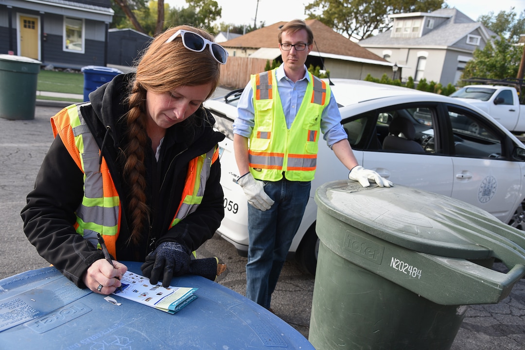 (Francisco Kjolseth  |  The Salt Lake Tribune)  Jen Farrell, lead outreach and education specialist for Salt Lake City Corporation Sanitation Division and permits coordinator David Johnston check on bins and leave a recycling guide after finding items that can't be recycled. 