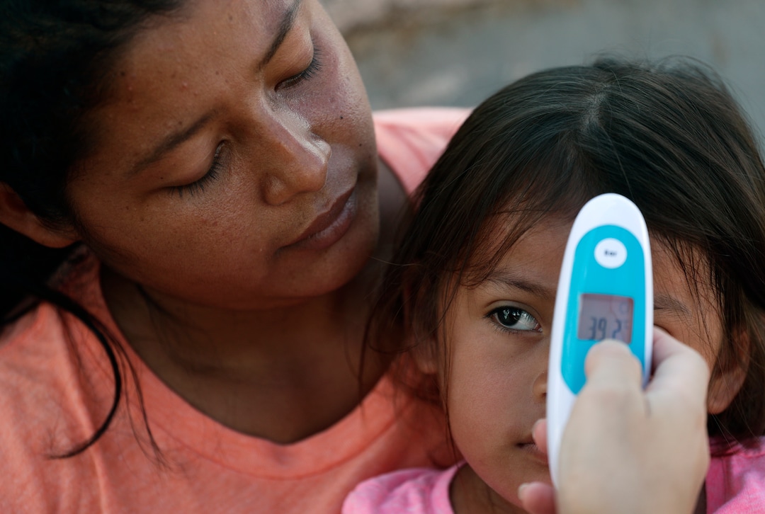 In this Tuesday, Nov. 5, 2019, photo, migrants see a health care worker as they receive medical care at a sidewalk clinic at a refugee camp in Matamoros, Mexico. The few doctors and nurses working in the camp are treating people including pregnant women and children with respiratory problems, skin conditions, diarrhea and other diseases that can be linked to the camp’s unsanitary conditions. (AP Photo/Eric Gay)