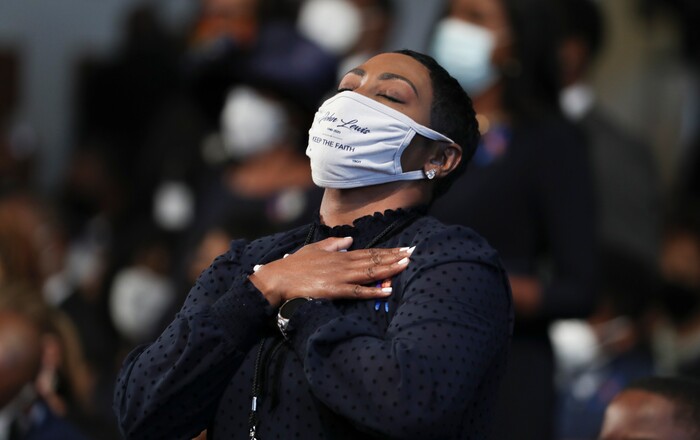 A woman becomes emotional during the funeral service for the late Rep. John Lewis, D-Ga., at Ebenezer Baptist Church in Atlanta, Thursday, July 30, 2020.  (Alyssa Pointer/Atlanta Journal-Constitution via AP, Pool)