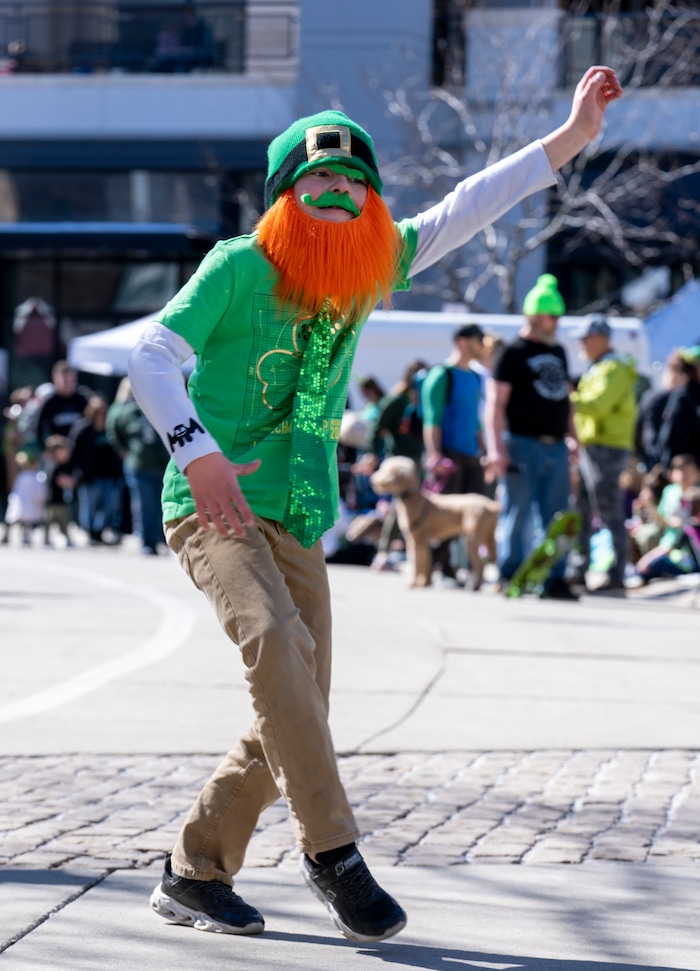 (Rick Egan | The Salt Lake Tribune) Ryder does a dance as he waits for the St. Patrick's Parade at the Gateway in Salt Lake City, on Saturday, March 12, 2022.