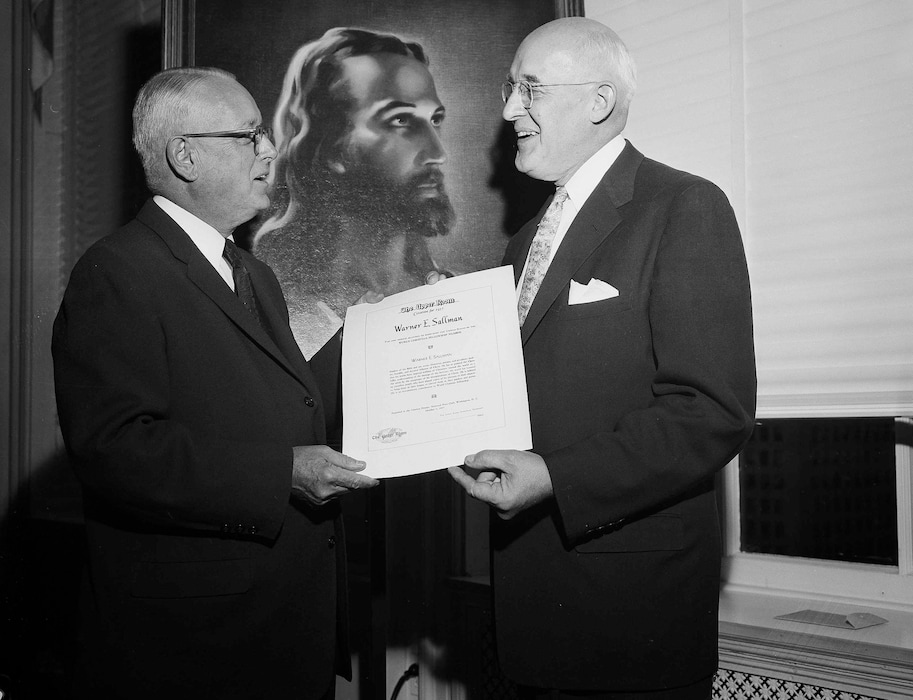 (Bob Schutz | AP file photo) The Rev. J. Manning Potts of Nashville, Tenn., left, presents the 1957 Upper Room Award for World Christianity Fellowship to artist Warner Sallman of Chicago at a dinner meeting of church and government officials, Oct. 3, 1957, at the National Press Club in Washington, D.C. Sallman was honored for his "Head Of Christ" painting, shown in background.
