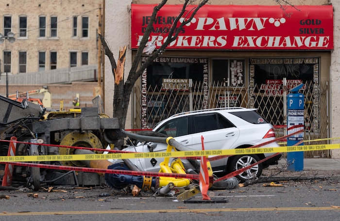 (Francisco Kjolseth | The Salt Lake Tribune) A collapsed drill rig is seen on Wednesday, March 16, 2022, at the intersection of State Street and 200 South. The rig toppled over Tuesday night at the site of the new Astra Tower, crushing two unoccupied parked cars and sending the crane operator to the hospital in serious condition.