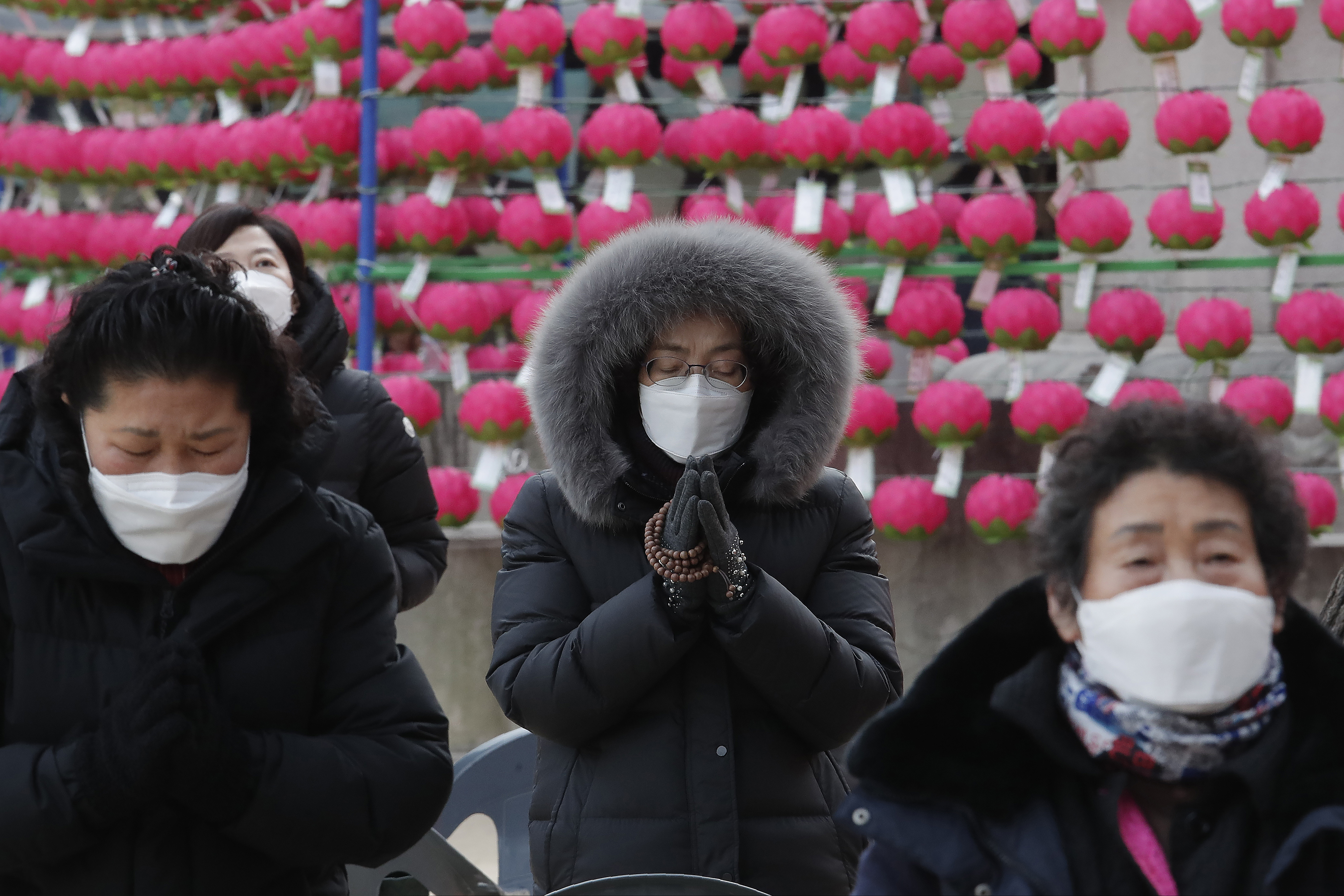 (Ahn Young-joon | AP file photo)  Parents wearing face masks as a precaution against the coronavirus pray during a special service to wish for their children's success in the upcoming college entrance exam on Thursday, Dec. 3, at the Jogye Temple in Seoul, South Korea, Sunday, Nov. 29, 2020.