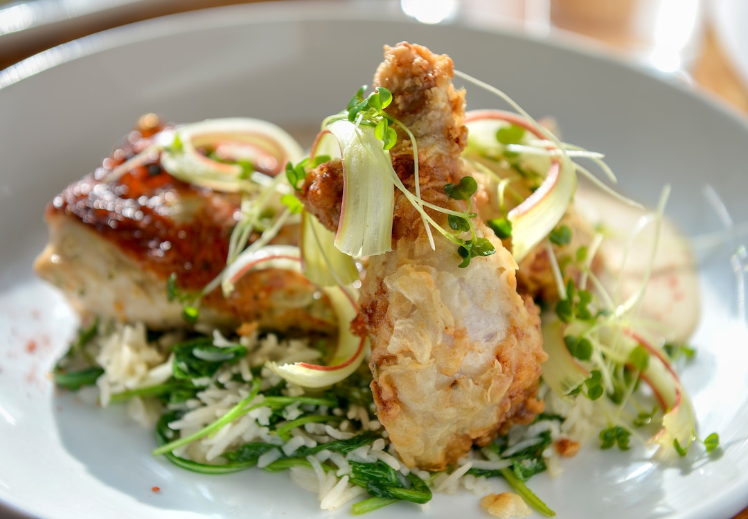Leah Hogsten  |  The Salt Lake Tribune  SLC Eatery's roasted petite hen serves up a crispy thigh, rice, greens, rhubarb-amaretto glaze and almond-buttermilk, $24. SLC Eatery's regular menu and the cart offerings include globally inspired flavors of Latin America, the Mediterranean and Asia.
