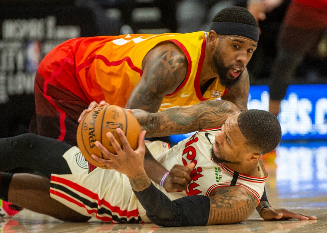 (Rick Egan  |  The Salt Lake Tribune)     Portland Trail Blazers guard Damian Lillard (0) goes for a lose ball along with Utah Jazz forward Royce O'Neale (23), in NBA action between the Utah Jazz and thePortland Trail Blazers in Salt Lake City, Friday, Feb. 7, 2020.