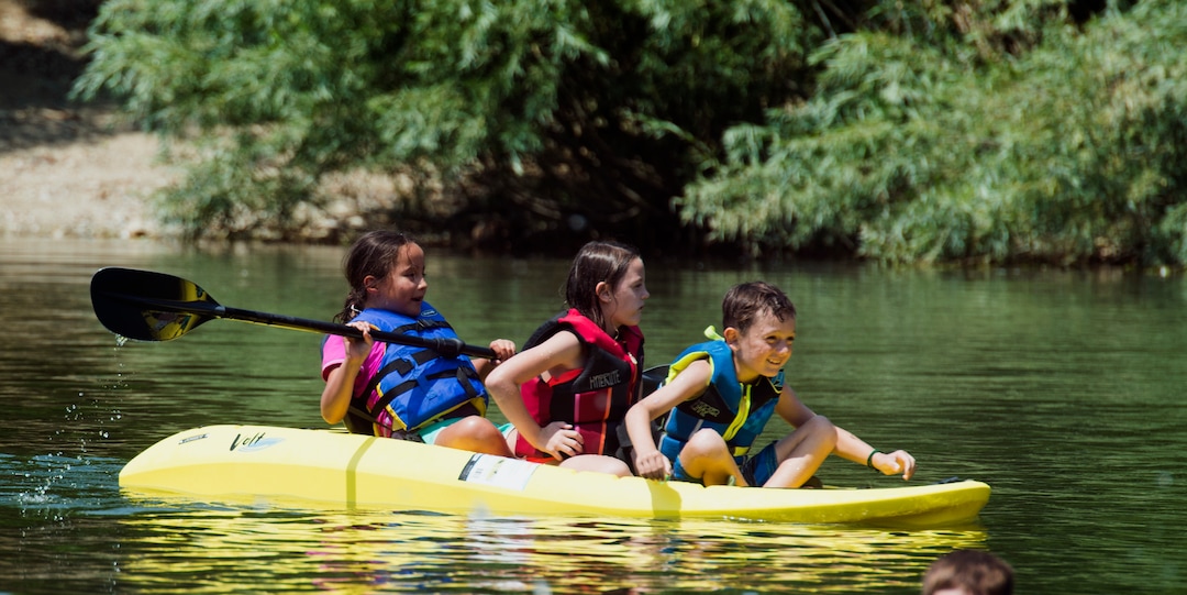 (Rick Egan  |  The Salt Lake Tribune)    Adalie Deleon Brynlee Thompson, Easton Gines, beat the heat by splashing around in kayaks on Farmington Pond, Thursday, July 26, 2018.