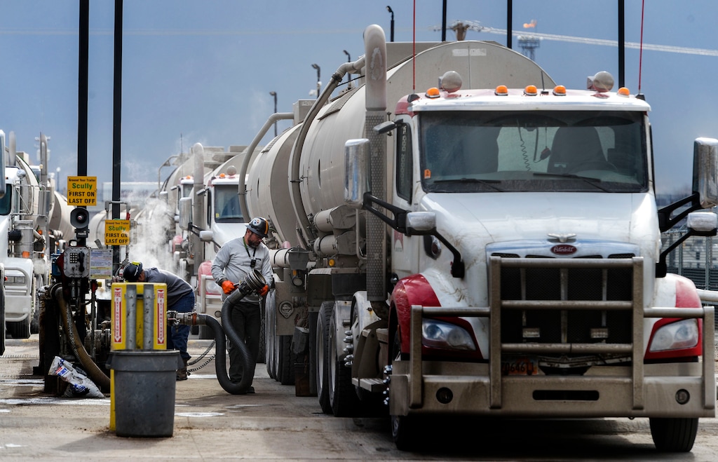 (Leah Hogsten | Tribune file photo) Fuel transport vehicle operators fill their trucks at the Marathon Petroleum station on 400 West in Salt Lake City, Jan. 9, 2020. Utah is speeding ahead with experiments on a "road user charge" that lawmakers hope will replace state gasoline tax by 2031.