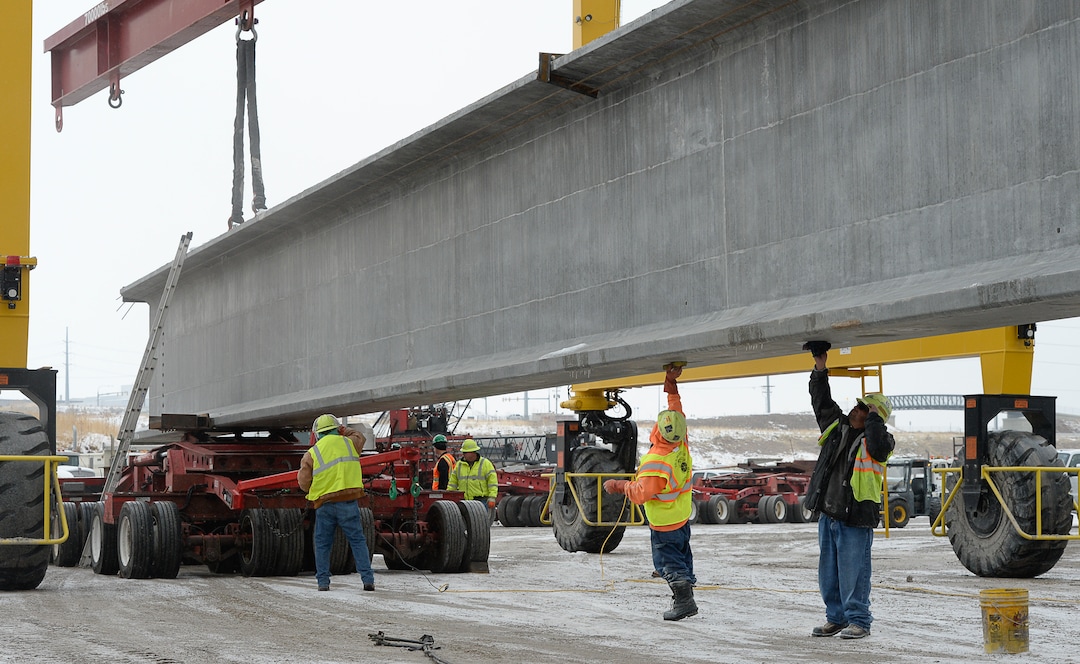 (Francisco Kjolseth  |  The Salt Lake Tribune)  UDOT gets ready to place some of the world's largest-ever bridge beams, and the largest in Utah state history with a span of 203 ft long and just over 8 ft tall, as crews load one on a truck following manufacturing at Forterra Structural Precast in Kearns on Tuesday, Dec. 11, 2018. A total of six beams will be installed in the technology corridor in Lehi later this week.