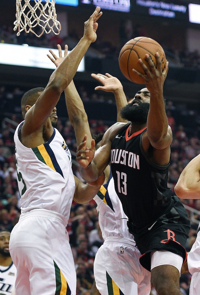 Houston Rockets guard James Harden (13) drives to the basket as Utah Jazz forward Derrick Favors, left, defends during the first half in Game 5 of an NBA basketball second-round playoff series, Tuesday, May 8, 2018, in Houston. (AP Photo/Eric Christian Smith)