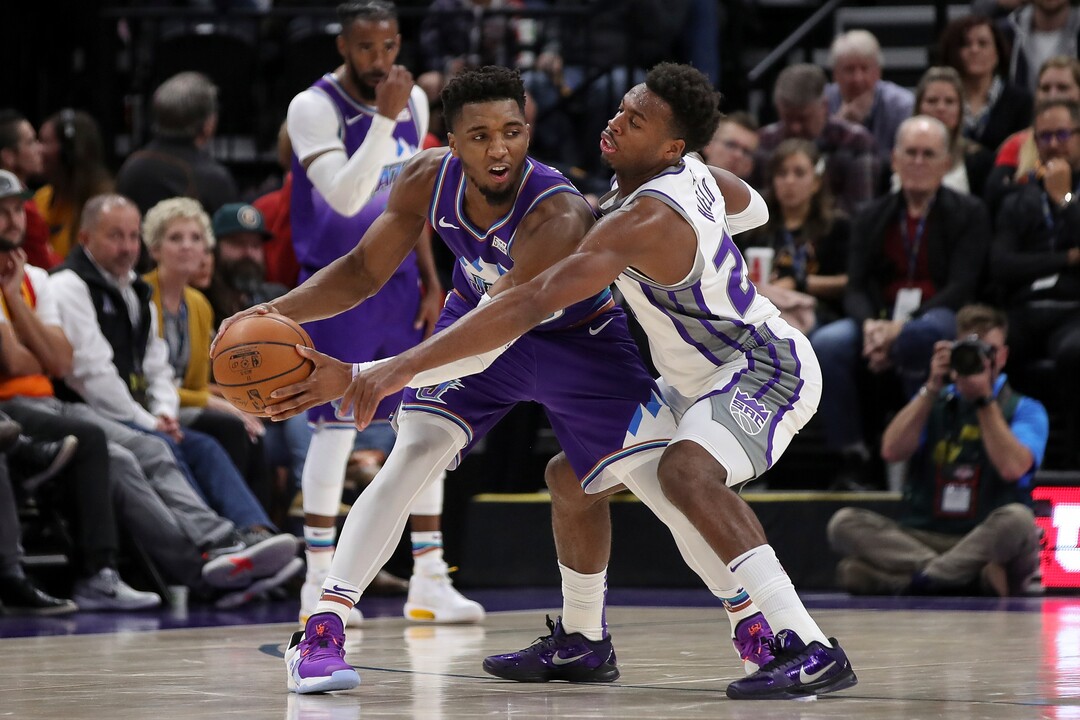 Utah Jazz guard Donovan Mitchell (45) protects the ball from Sacramento Kings guard Buddy Hield (24) during the second quarter of an NBA basketball game, Saturday, Oct. 26, 2019, in Salt Lake City. (AP Photo/Chris Nicoll)
