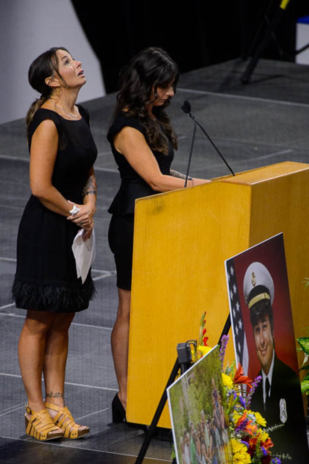 (Trent Nelson | The Salt Lake Tribune)  Gina Zipp and Monica Brinkerhoff, sisters of Matthew Burchett, speak at the funeral services for Battalion Chief Matthew Burchett at the Maverik Center in West Valley City, Monday Aug. 20, 2018.