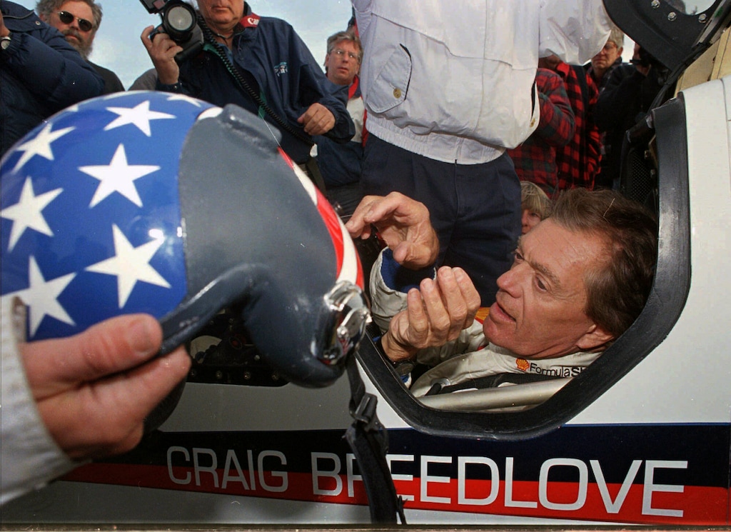 (Rich Pedroncelli | AP) Former land speed record holder Craig Breedlove reaches for his helmet prior to making his first test run in his car "Spirit of America" Wednesday, Oct 23, 1996, in the Black Rock Desert near Gerlach Nev. Craig Breedlove, who set land-speed records by topping 400, 500 and 600 mph in jet-powered cars nicknamed Spirit of America, has died. He was 86. Breedlove died at his home in Rio Vista, California on April 4, 2023.
