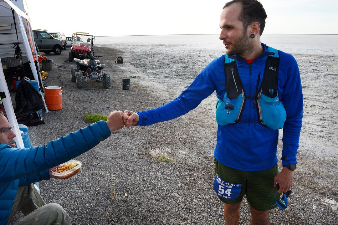 (Scott Sommerdorf | The Salt Lake Tribune)Fellow runner Todd Vogel, left, congratulates Alex Doolan after Doolan finished the Salt Flats 100 Endurance Run, Saturday, May 5, 2018.