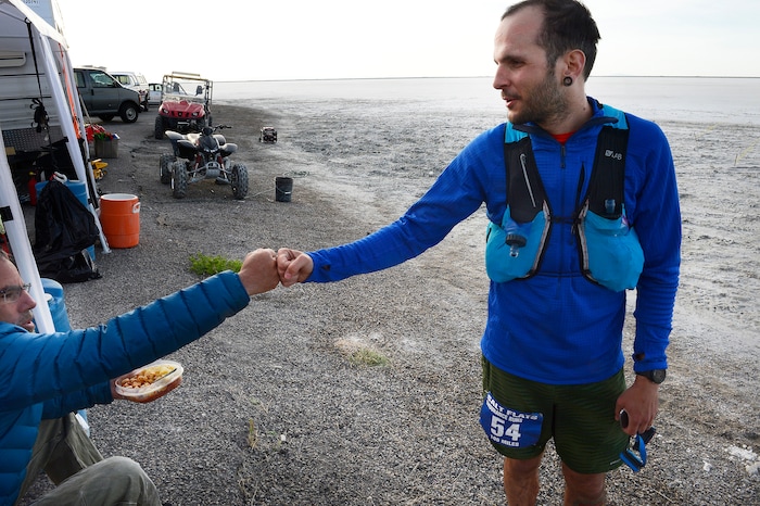 (Scott Sommerdorf | The Salt Lake Tribune)
Fellow runner Todd Vogel, left, congratulates Alex Doolan after Doolan finished the Salt Flats 100 Endurance Run, Saturday, May 5, 2018.

