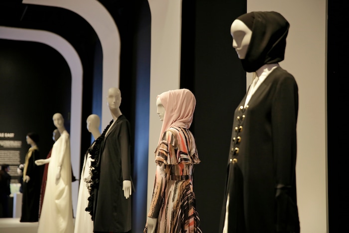In this photo taken Thursday, Sept. 20, 2018, a number of headscarves and ensembles are seen in the exhibit Contemporary Muslim Fashions at the M. H. de Young Memorial Museum in San Francisco. The first major museum exhibition of contemporary Muslim women's fashion reflects designs from around the world that are vibrant and elegant, playful and diverse. The show's creators hope the exhibit will show Muslim women as real people who can choose what they wear rather than as subjects ordered to cover their entire bodies or restricted in what they can wear. The exhibit opens on Saturday. (AP Photo/Eric Risberg)