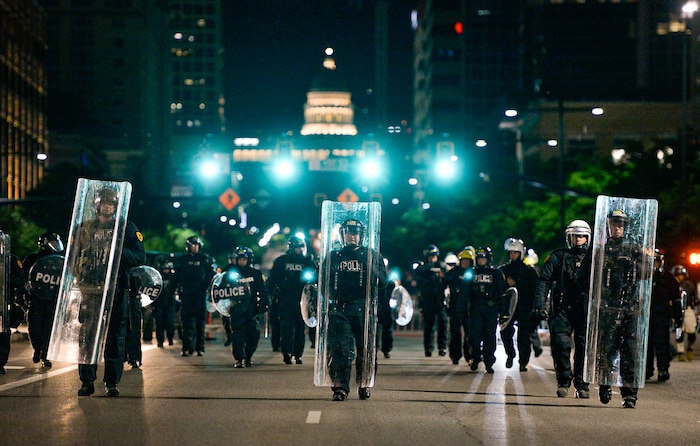 (Francisco Kjolseth  |  The Salt Lake Tribune) Police with shields fill the north bound lane of State street and push people south as they enforce a mandatory curfew in Salt Lake City on Monday, June 1, 2020, following violence and unrest over the weekend due to the death of George Floyd by police.