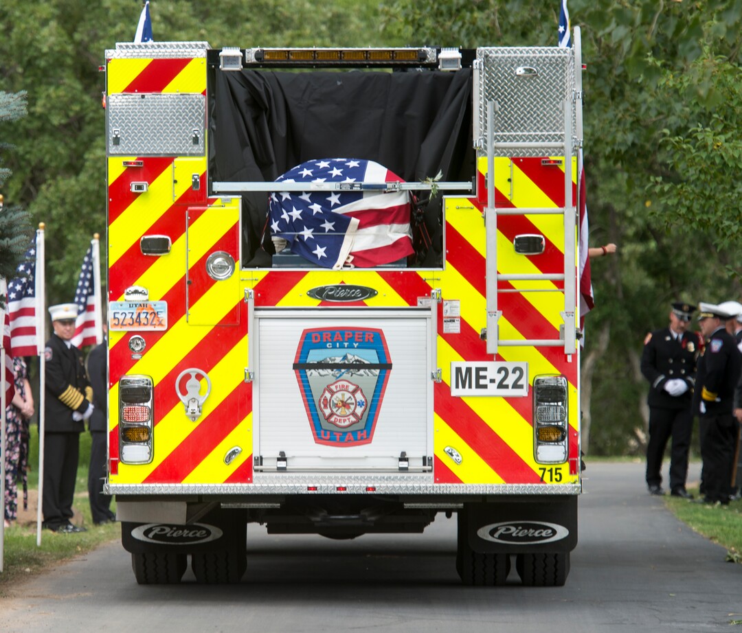 (Rick Egan  |  The Salt Lake Tribune)  The casket is brought to the cemetery carrying Matthew Burchett in a Draper fire engine 21 to Eastlawn Memorial Hills Cemetery in Provo, Monday, Aug. 20, 2018.