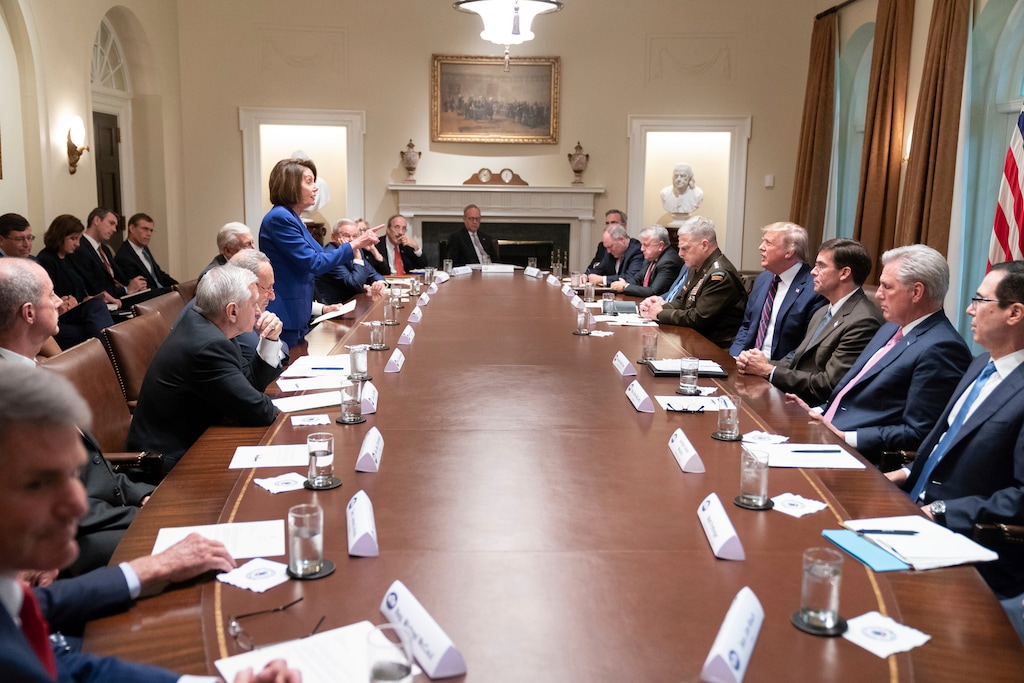 (Official White House Photo by Shealah Craighead via AP) In this photo released by the White House, President Donald Trump, center right, meets with House Speaker Nancy Pelosi, standing left, Congressional leadership and others, Wednesday, Oct. 16, 2019, in the Cabinet Room of the White House in Washington.