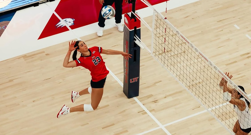 (Utah Tech University) Utah Tech volleyball player Kennedi Knudsen attempts to spike the ball over a defender.
