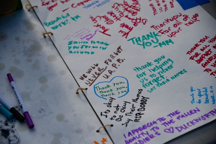 (Francisco Kjolseth  |  The Salt Lake Tribune) People gather for a vigil on the six-year anniversary of Dillon Taylor’s death by the murals of people killed by police near 800 South and 300 West in Salt Lake City on Tuesday, August 11, 2020. Multiple families who’s loved one’s are depicted on the walls joined the vigil as they moved from portrait to portrait to remember them.