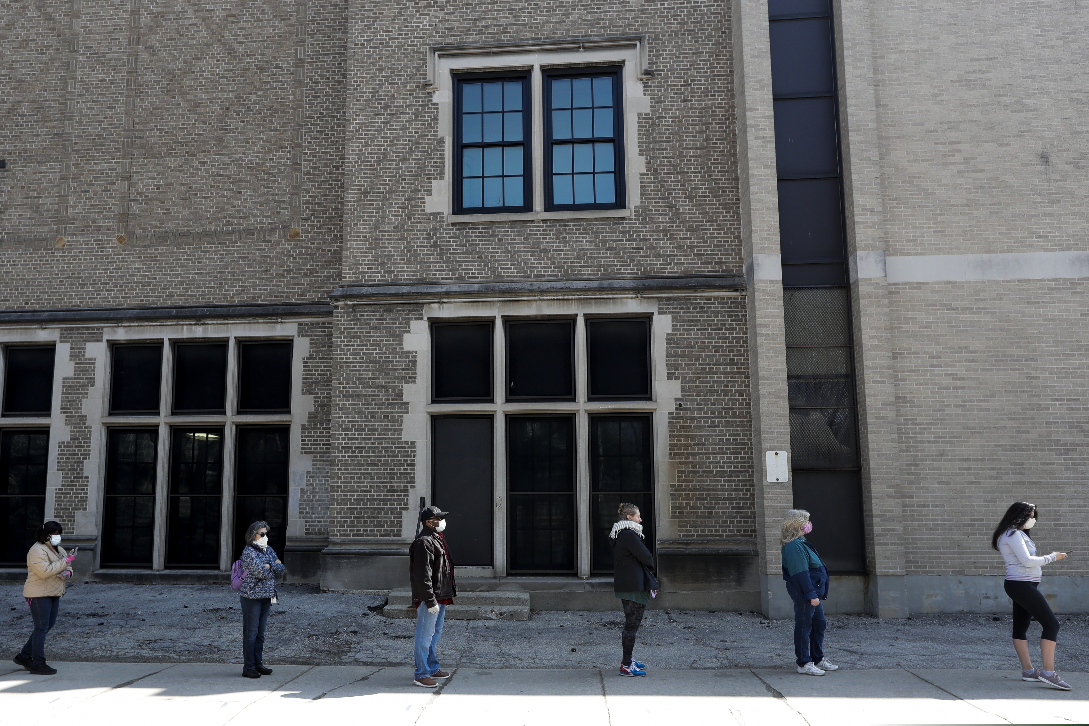 Voters observe social distancing guidelines as they wait in line to cast ballots at Washington High School while ignoring a stay-at-home order over the coronavirus threat to vote in the state's presidential primary election, Tuesday April 7, 2020, in Milwaukee. (AP Photo/Morry Gash)