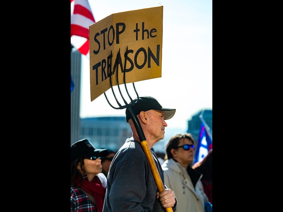 (Rick Egan | The Salt Lake Tribune). A small crowd of Trump protesters gather at the capitol with signs, flags and guns on Wednesday, Jan. 6, 2021.