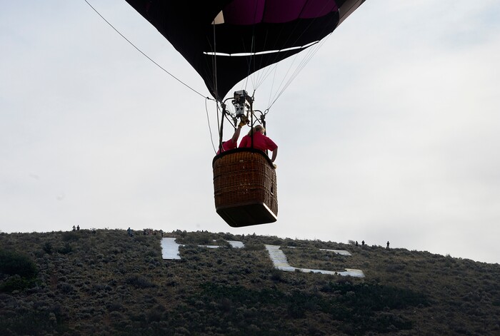 (Scott Sommerdorf | The Salt Lake Tribune)
A balloon hovers over Park City's "PC" at the 4th annual Autumn Aloft Hot Air Balloon Festival in Park City, Sunday, September 17, 2017.