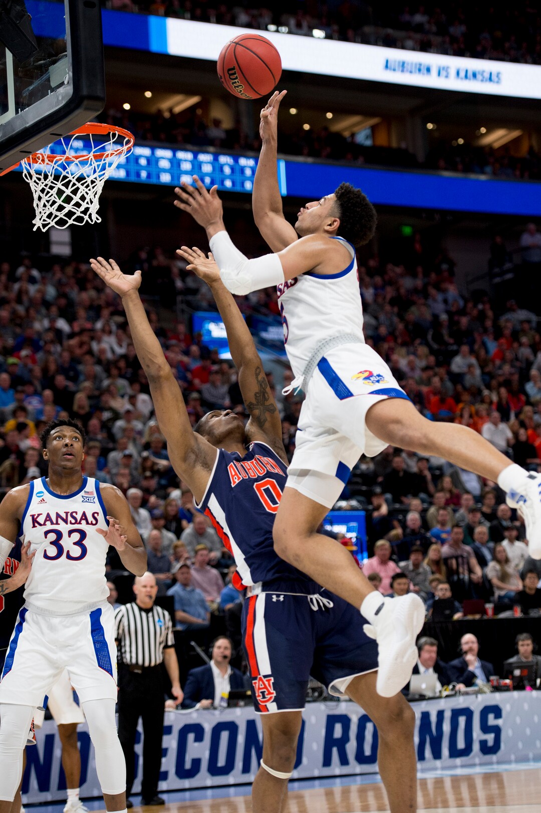 (Leah Hogsten  | The Salt Lake Tribune)  Kansas Jayhawks guard Quentin Grimes (5) shoots over Auburn Tigers forward Horace Spencer (0) as Auburn faces Kansas in the second round of the NCAA tournament in Salt Lake City on Saturday, March 23, 2019.