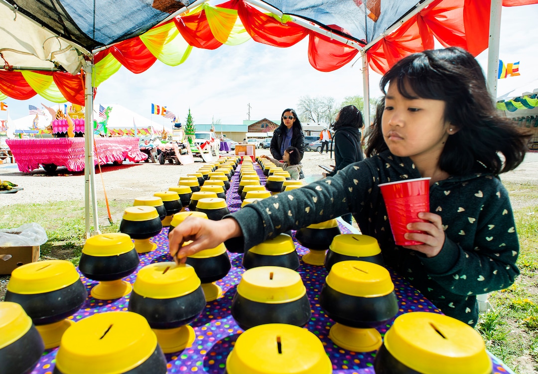 (Rick Egan  |  The Salt Lake Tribune)     Jawmarana Trai 8, puts money in the bank for the monks,  during the Wat Lao Salt Lake Buddharam Utah, New Year Celebration, in West Valley City, Sunday, April 28, 2019.