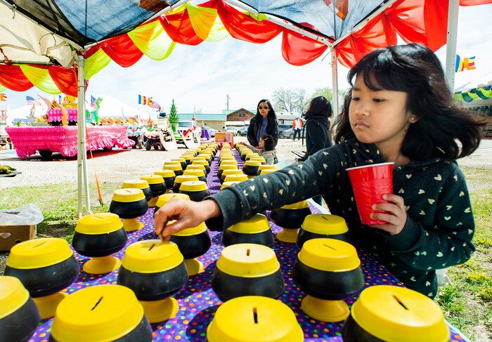 (Rick Egan  |  The Salt Lake Tribune)     Jawmarana Trai 8, puts money in the bank for the monks,  during the Wat Lao Salt Lake Buddharam Utah, New Year Celebration, in West Valley City, Sunday, April 28, 2019.


