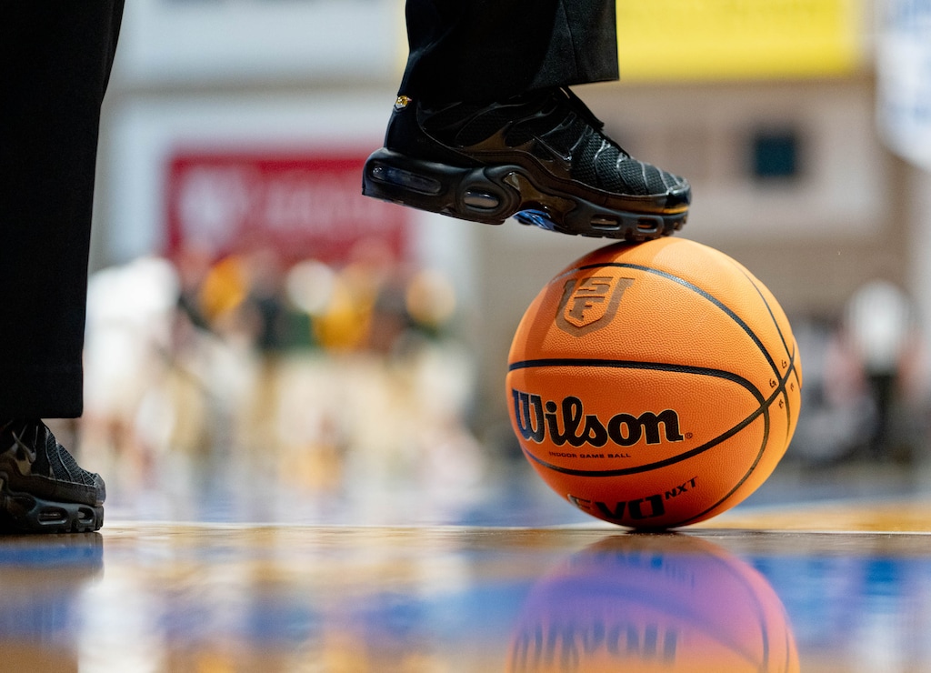 (Francisco Kjolseth | The Salt Lake Tribune) A referee rests a foot atop a basketball during a game at Salt Lake Community College's Bruin Arena in Taylorsville earlier this year.