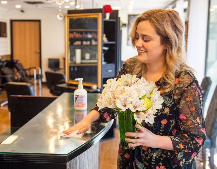 (Rick Egan  |  The Salt Lake Tribune)     Alyssa Brown wipes the counter at Mid City Salon to protect employees and customers during the coronavirus, Saturday, March 21, 2020.
