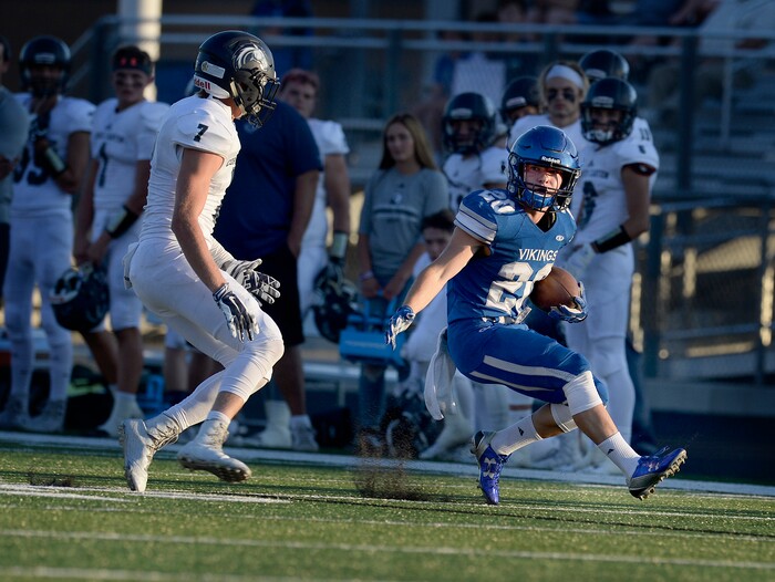 (Scott Sommerdorf | The Salt Lake Tribune) Corner Canyon DB Matthew Eberling hems in Viking WR Dane Christiansen after a long catch and run during first half play. led Pleasant Grove 14-3 at the half, Friday, August 18, 2017.