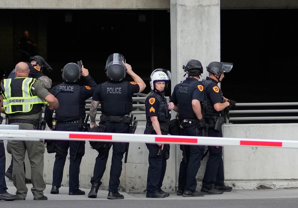 (Francisco Kjolseth  | The Salt Lake Tribune) Officers search for a shooter during a "No Kings" demonstration in downtown Salt Lake City on Saturday, June 14, 2025.