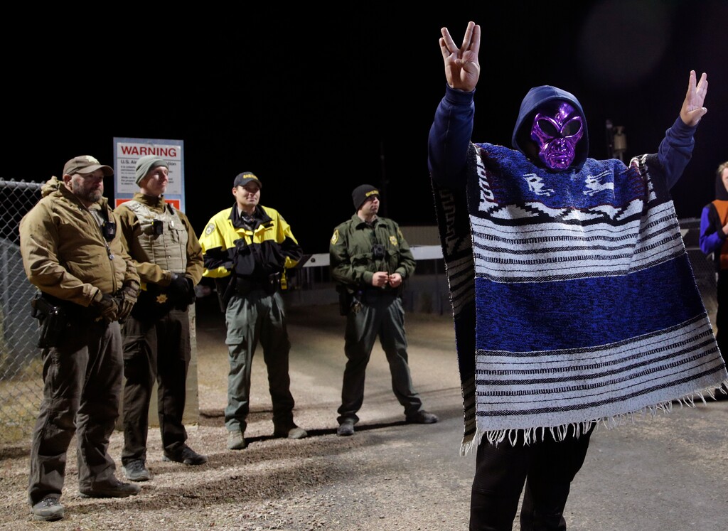 (John Locher | AP Photo) A man in an alien mask stands at an entrance to the Nevada Test and Training Range near Area 51 Friday, Sept. 20, 2019, outside of Rachel, Nev. People gathered at the gate inspired by the "Storm Area 51" internet hoax.