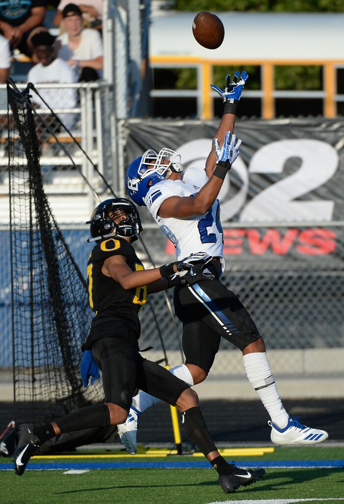 (Francisco Kjolseth  |  The Salt Lake Tribune)  Bingham's Jared Greenfield tries to pull in a long pass as Orem's Jacob Robinson puts on the pressure for the start of the football season in Orem on Thursday, Aug. 16, 2018.