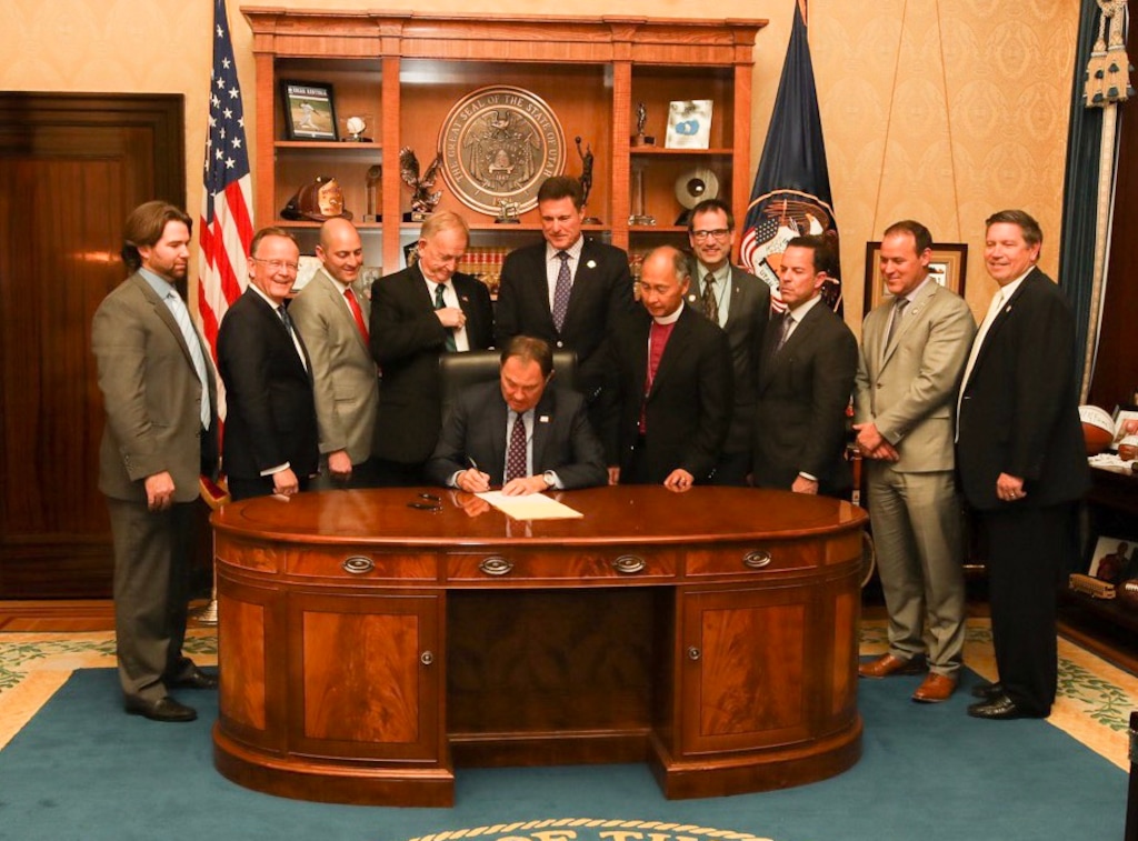 (Courtesy Governor's Office) Utah Gov. Gary Herbert, center, signs SB96, Monday, Feb. 11, 2019. Looking on are lawmakers who supported the bill, along with Matt Slonaker, of the Utah Health Policy Project, far left, and Rev. Scott Hayashi, of the Episcopal Diocese of Utah,  standing right of governor.