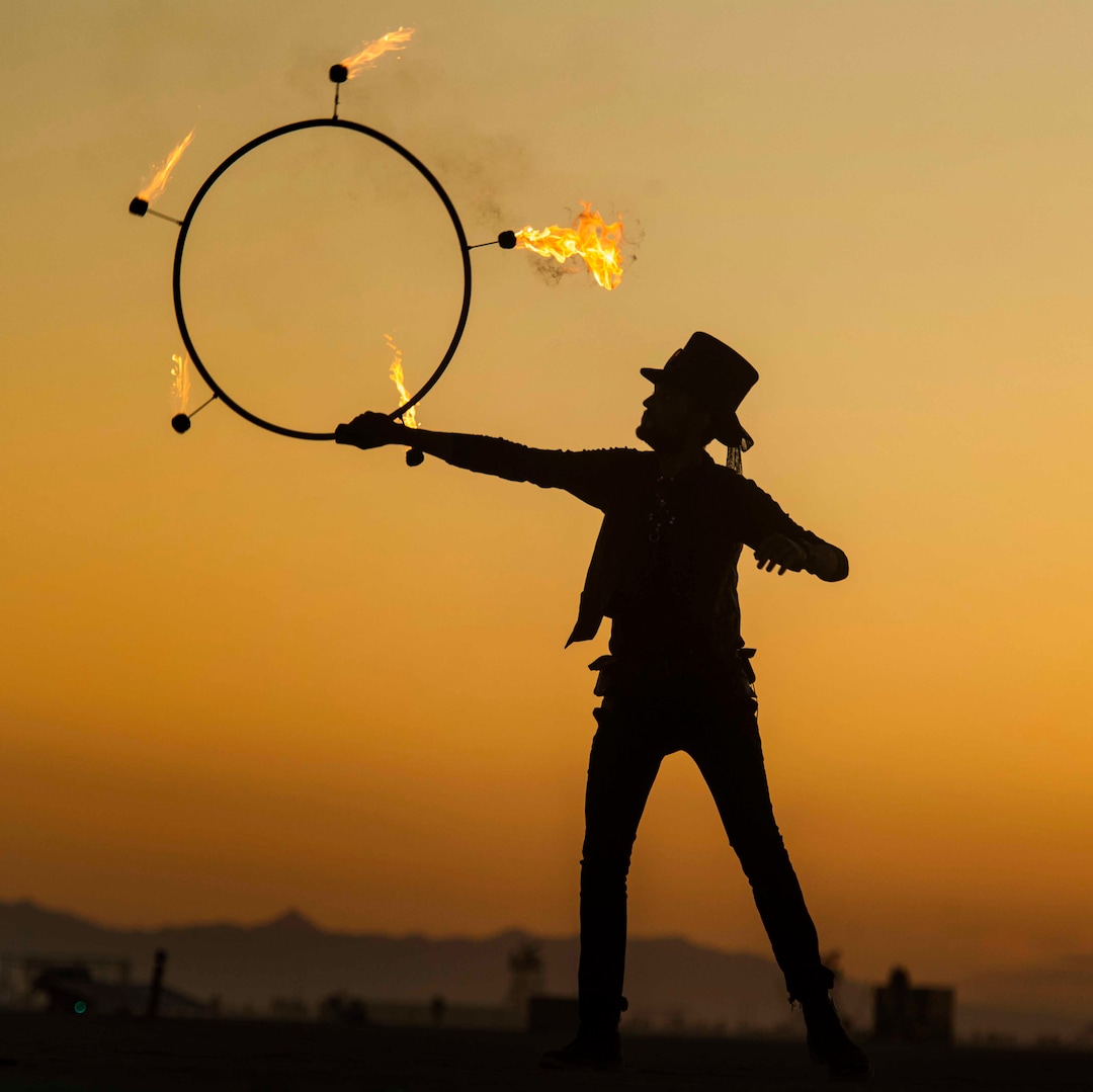 (Rick Egan  |  The Salt Lake Tribune)   Bryan Pope, from Denver Colorado, spins fire before sunrise, at Burning Man, Saturday, Aug. 31, 2019.