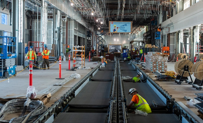 (Rick Egan  |  The Salt Lake Tribune)       Workers construct the moving sidewalk in the new north concourse, that will open in phase one, In less than a year. Monday, Sept. 23, 2019.