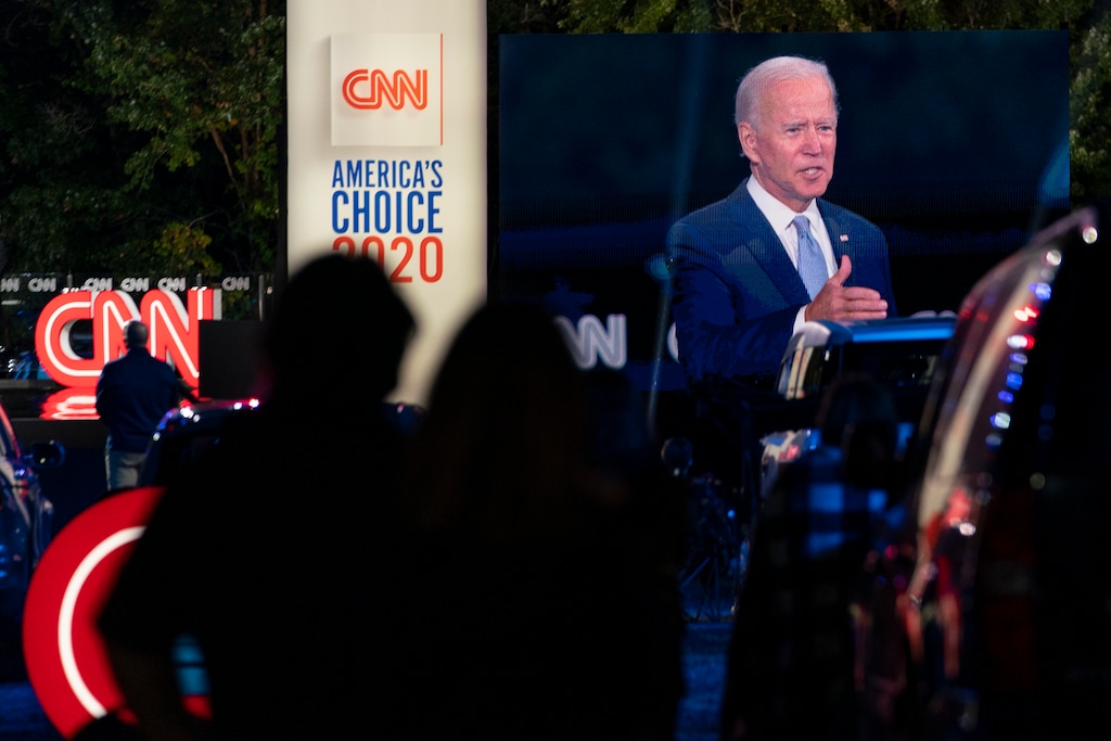 (Carolyn Kaster | The Associated Press) Audience members watch from their cars as Democratic presidential candidate former Vice President Joe Biden, seen on a monitor, speaks during a CNN town hall in Moosic, Pa., Thursday, Sept. 17, 2020.