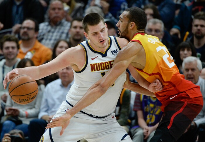 (Francisco Kjolseth  |  The Salt Lake Tribune)  Denver Nuggets center Nikola Jokic (15) tries to push past Utah Jazz center Rudy Gobert (27) as the Utah Jazz host the Denver Nuggets in their NBA game at Vivint Smart Home Arena Tuesday, April 9, 2019, in Salt Lake City.