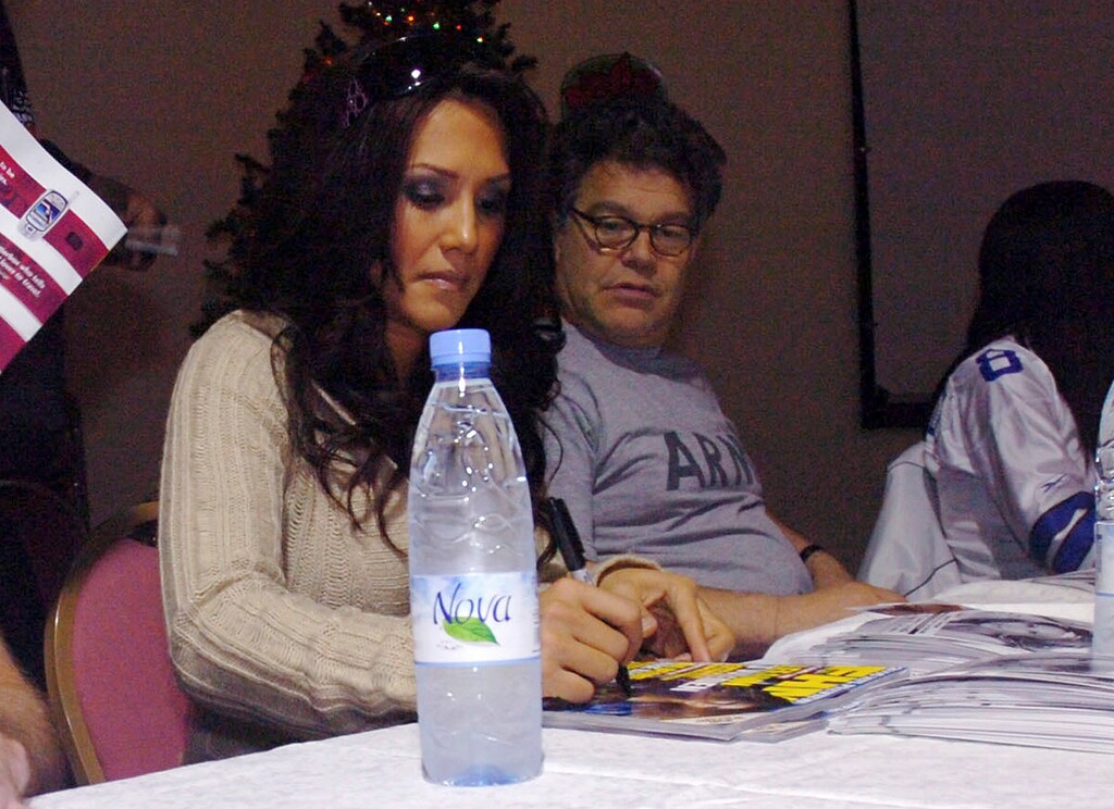 In this image provided by the U.S. Army, sportscaster Leeann Tweeden and then-comedian Al Franken meet and greet military members during an autograph signing session of the USO Sergeant Major of the Army's 2006 Hope and Freedom Tour in Camp Arifjan, Kuwait, on Dec. 14, 2006. Sen. Al Franken, D-Minn., apologized Nov. 16, 2017, after Tweeden accused him of forcibly kissing her during the 2006 USO tour. Colleagues, including fellow Democrats, urged a Senate ethics investigation. Tweeden also accused Franken of posing for a photo with his hands on her breasts as she slept, while both were performing for military personnel two years before Franken was elected to the Senate. (Sgt. Thomas Day/U.S. Army 40th via AP)